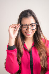 Portrait of happy young beautiful Indian businesswoman with eyeglasses winking