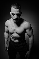 Fototapeta premium A man with raised muscles and a naked torso