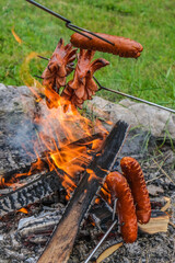 Toasting sausages o the fire