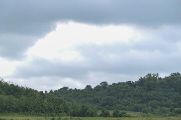 Obraz premium rain clouds over forest hills