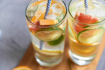 Health care, fitness, healthy nutrition diet concept. Fresh cool homemade citrus infused detox water with grapefruit, orange, lemon and lime and ice in a jug and glasses for spring summer days.