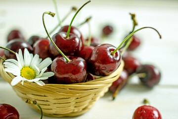 Tasty ripe cherry on a light wooden table, copy space
