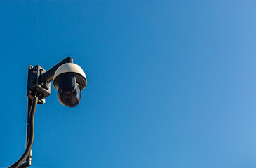 City monitoring. Public safety. CCTV camera against the blue sky.