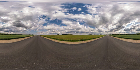 Full spherical seamless hdri panorama 360 degrees angle view on no traffic asphalt road among fields with cloudy sky in equirectangular projection, VR AR content