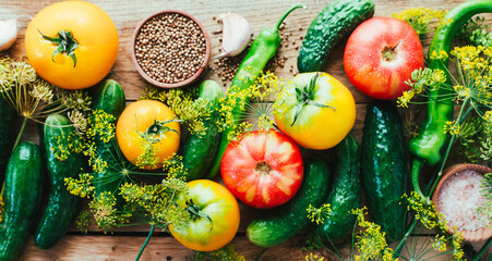 Harvesting seasonal vegetables, cucumbers, tomatoes, peppers and spices on a wooden background