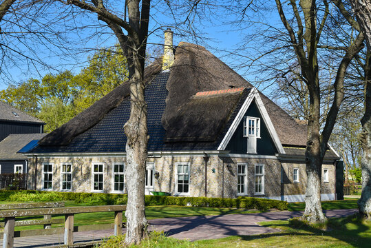 Original old Dutch farmhouse with thatched roof.