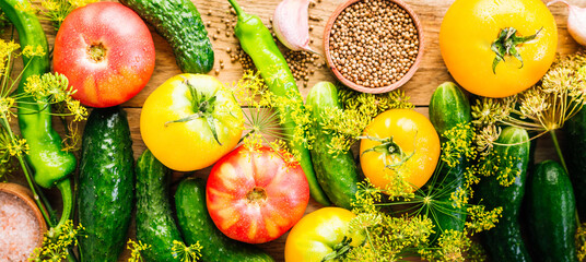 Harvesting seasonal vegetables, cucumbers, tomatoes, peppers and spices on a wooden background