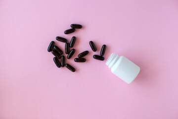 White pill packaging on pink background. Tablets. Close-up.