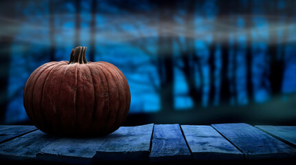 One spooky halloween pumpkin blank template on a wooden bench with a misty forest night background with space for product placement. - obrazy, fototapety, plakaty