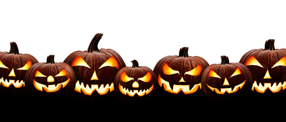 A large group of seven spooky halloween lanterns, Jack O Lantern, with evil face and eyes isolated against a white background.
