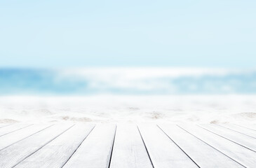 Wooden table top on blue sea and white sand beach background.