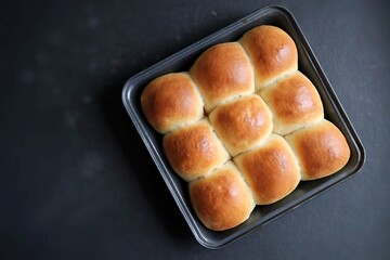 Freshly baked homemade Mumbai style golden Ladi pav or soft dinner bread roll in a baking tray....