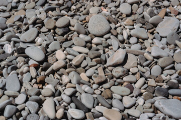 Sea stones. Pebble beach. A beach made of stones.