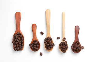 A collection of instant roasted coffee beans in a separate wooden spoon on a white background, top view, healthy food and beverage concept