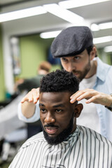 Young African-american man end haircut after visit barbershop