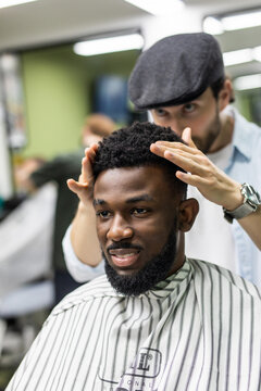 Young African-american man end haircut after visit barbershop