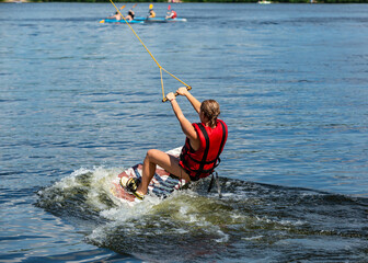 Fototapeta premium Wakeboard. Woman surfing on the river on a board