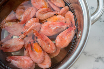 Prawns cooked in a pan with water top view
