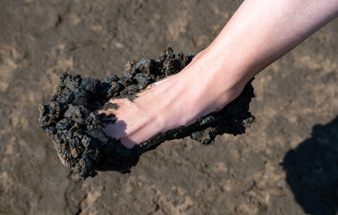 Women foot full of mud after a mudflat hike in St. Peter Ording