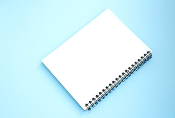 Open white notebook on mint background. Back to school. Top view. Copy space for text