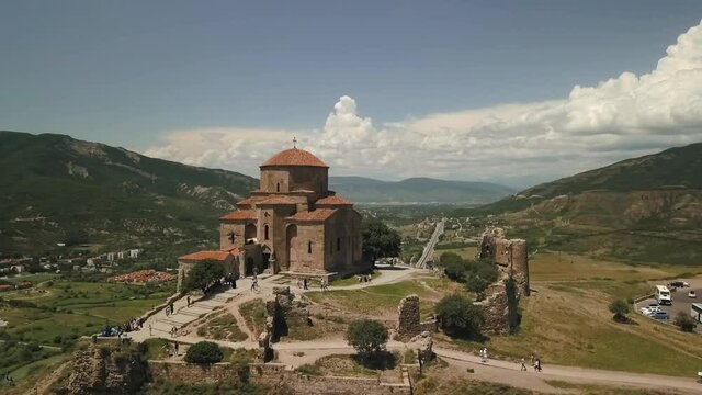 Drone above Church in Georgia Tbilisi Mtskheta river road cars pass by
