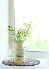wild flowers and herbs in vase on windowsill. Scandinavian style minimalism. Elegant lifestyle.