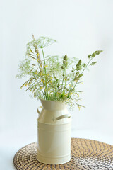 wild flowers and herbs in vase on white background. Scandinavian style minimalism. Elegant lifestyle