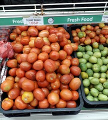 A collection of fresh tomatoes sold in fruit shops during the day.
