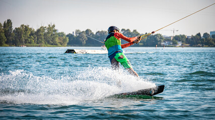 Male wakeboarder being pulled on a lake