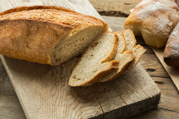 Homemade bread on cutting board, sliced and prepared for breakfast. Healthy lifestyle with fresh products without gmo.