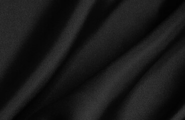 Black folded fabric. Liquid wavy background.