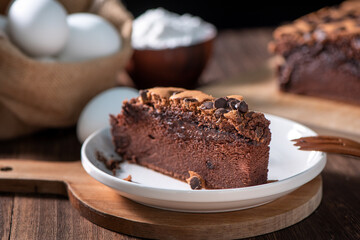 Chocolate flavor Taiwanese traditional sponge cake (Taiwanese castella kasutera) on a wooden tray background table with ingredients, close up.