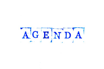 Blue ink of rubber stamp in word agenda on white paper background
