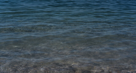 Clear sea water, and rocks on the bottom. Black sea with blue and emerald green water.