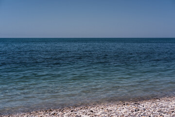 Clear blue-blue sea with a rocky shore. Black sea coast.