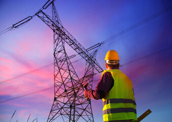 Engineer during power line inspection. Electrician at work. Production and supply of energy from...