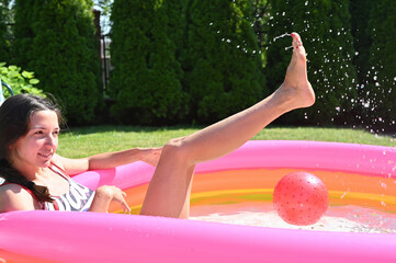 girl sitting in an inflatable pool