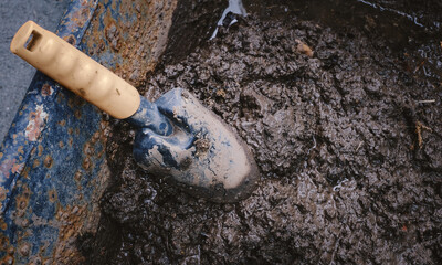 dirty shovel and wet mud on the wheelbarrow. tool prepare for gardening.