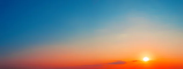 Foto op Canvas Panorama of dramatic sunset sky with setting sun © alexlukin