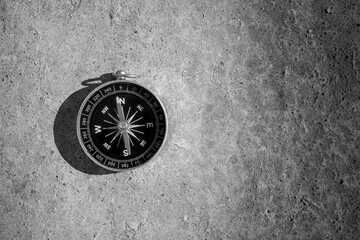 Fototapeta na wymiar Compass on the ground. - travel and transportation concept.