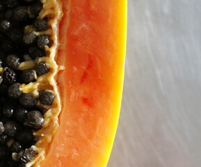 Close up of papaya fruit on the kitchen table. Macro papaya fruits.