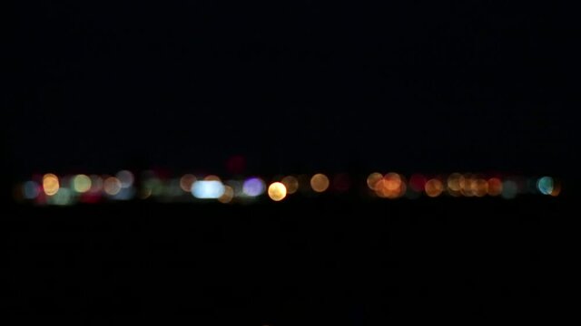 The bokeh effect of the city&rsquo;s light at a great distance in the moisture vapor. Illustration of a mirage of the city in the dark.