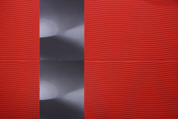 Wavy red tile with black parts installation. Bathroom wall texture.