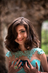 Naklejka premium Beautiful young girl in a dress with butterflies on the beach. Portrait