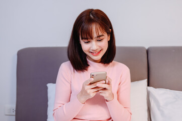 Asian woman online shopping at home. New normal lifestyle and Social Distancing.