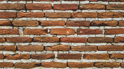 Brick wall with cement mortar close-up.