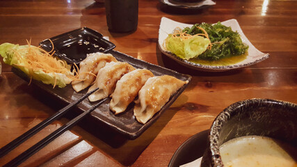 Gyoza lightly fried. Soy sauce and vegetables.