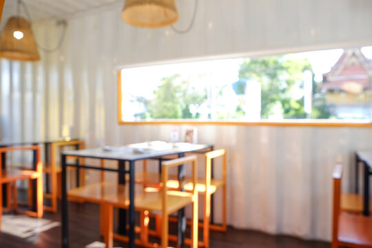 Blurred coffee shop or cafe restaurant with abstract bokeh sunny light image background