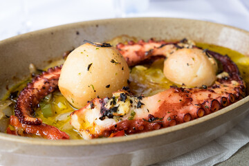 Traditional portuguese dish popular on Madeira island - polvo a lagareiro, octopus with baked potatoes and olive oil.