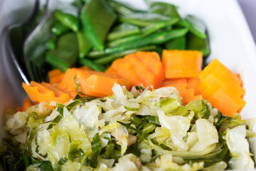 A variety of mixed vegetable salads of Madeira island - coleslaw salad with seaweed, pickled carrot and salty green beans